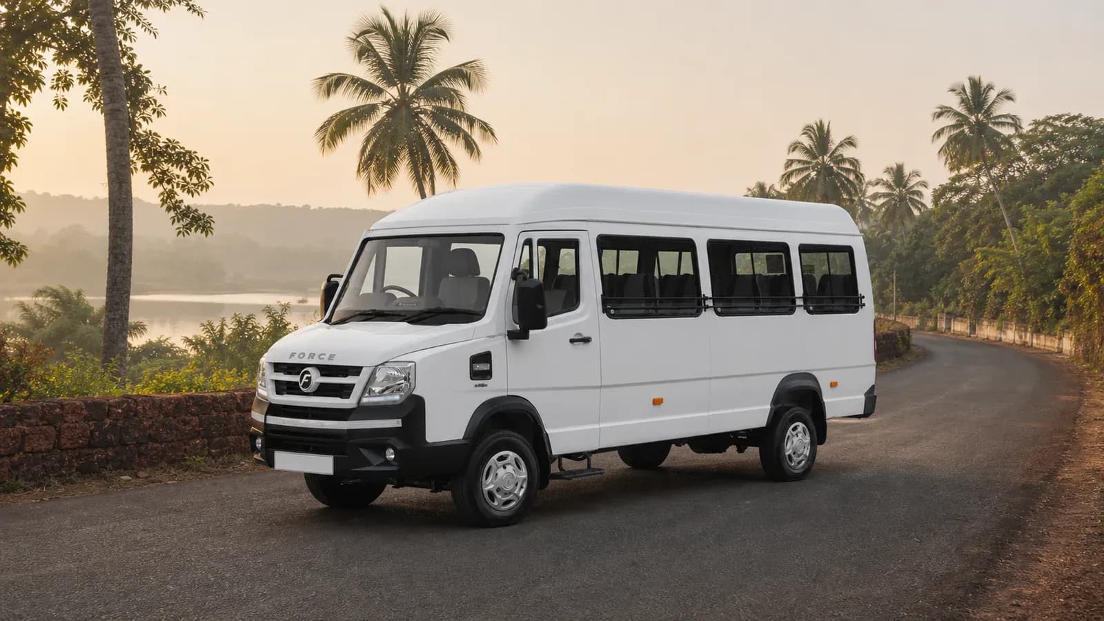 White Force Traveller N 3700WB 17-seat passenger vehicle on a quiet Goa road
