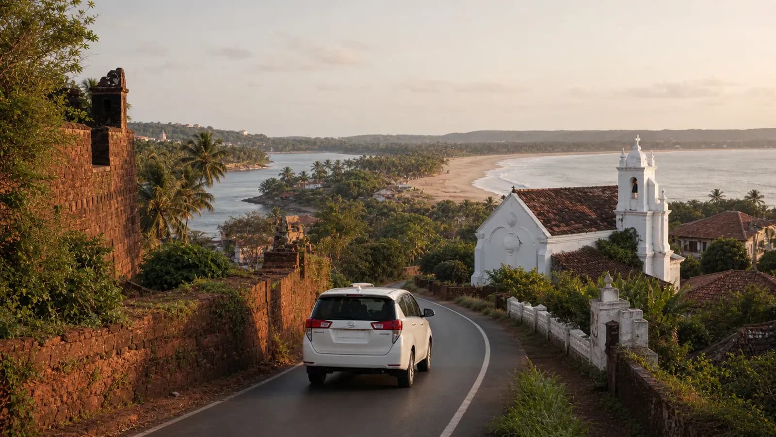 White MPV travelling between a laterite fort, Goan chapel and palm-lined coast