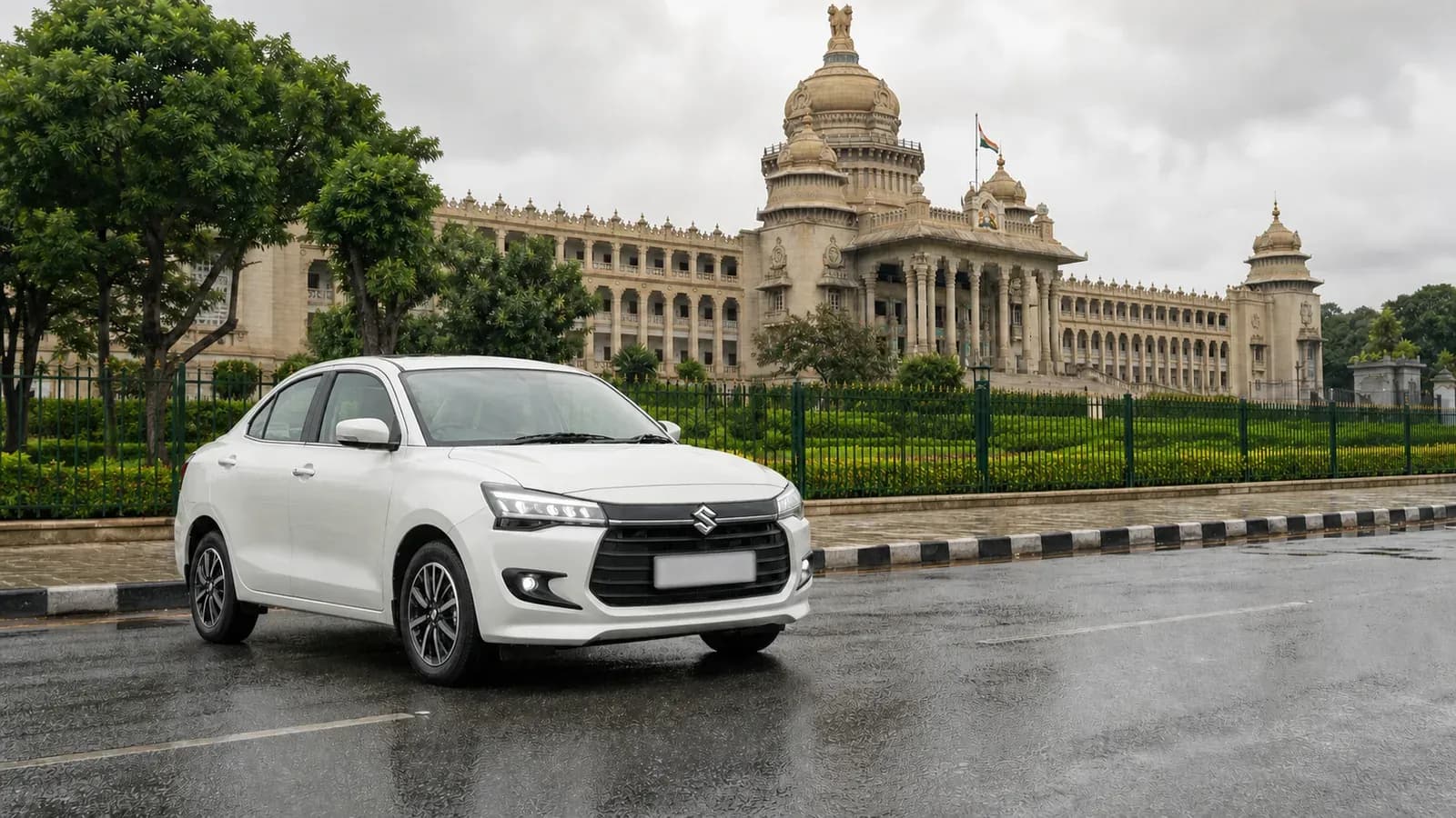 White Maruti Suzuki Dzire arriving in Bengaluru near Vidhana Soudha after rain