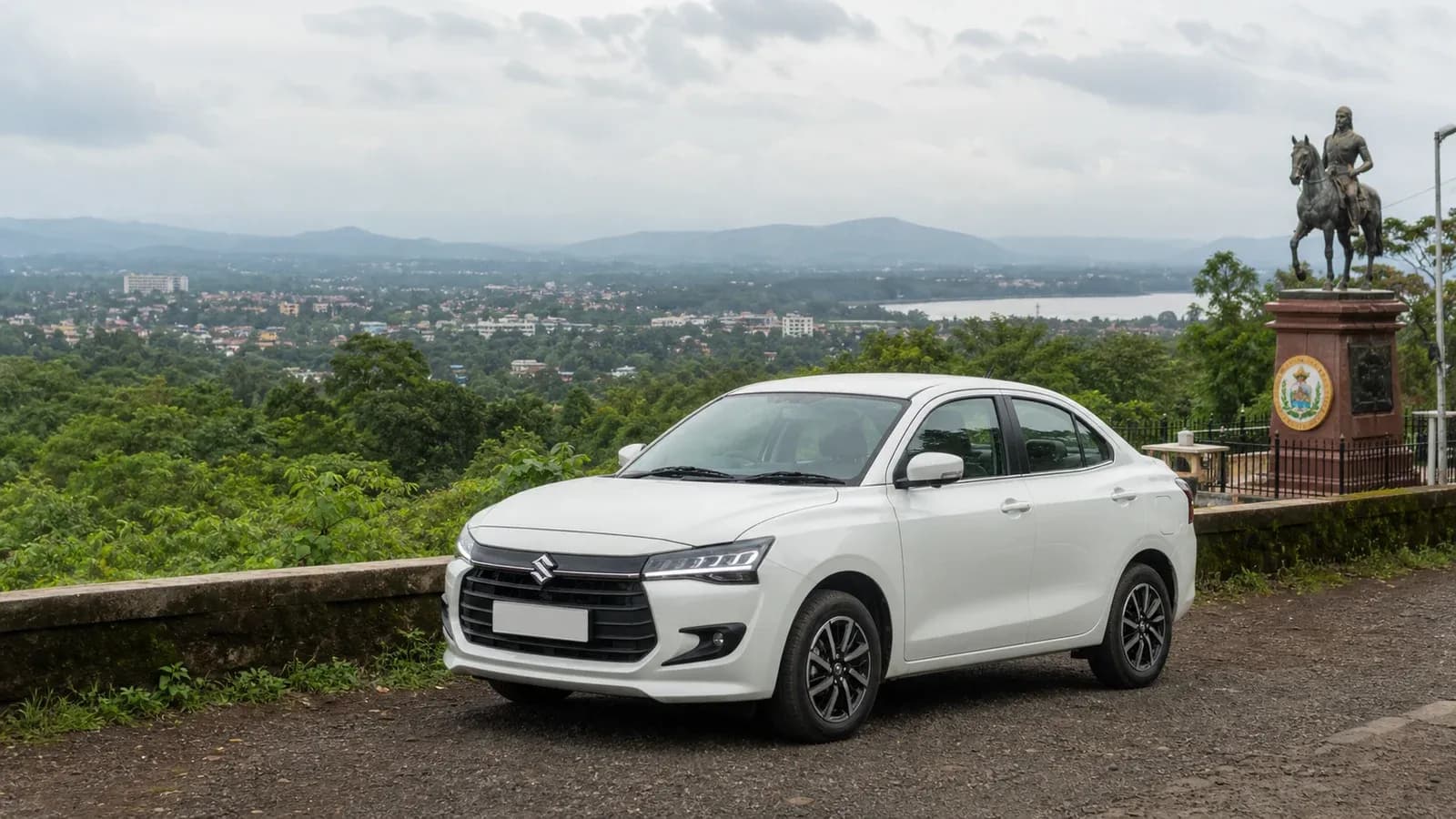 White Maruti Suzuki Dzire above green Belgaum after the monsoon