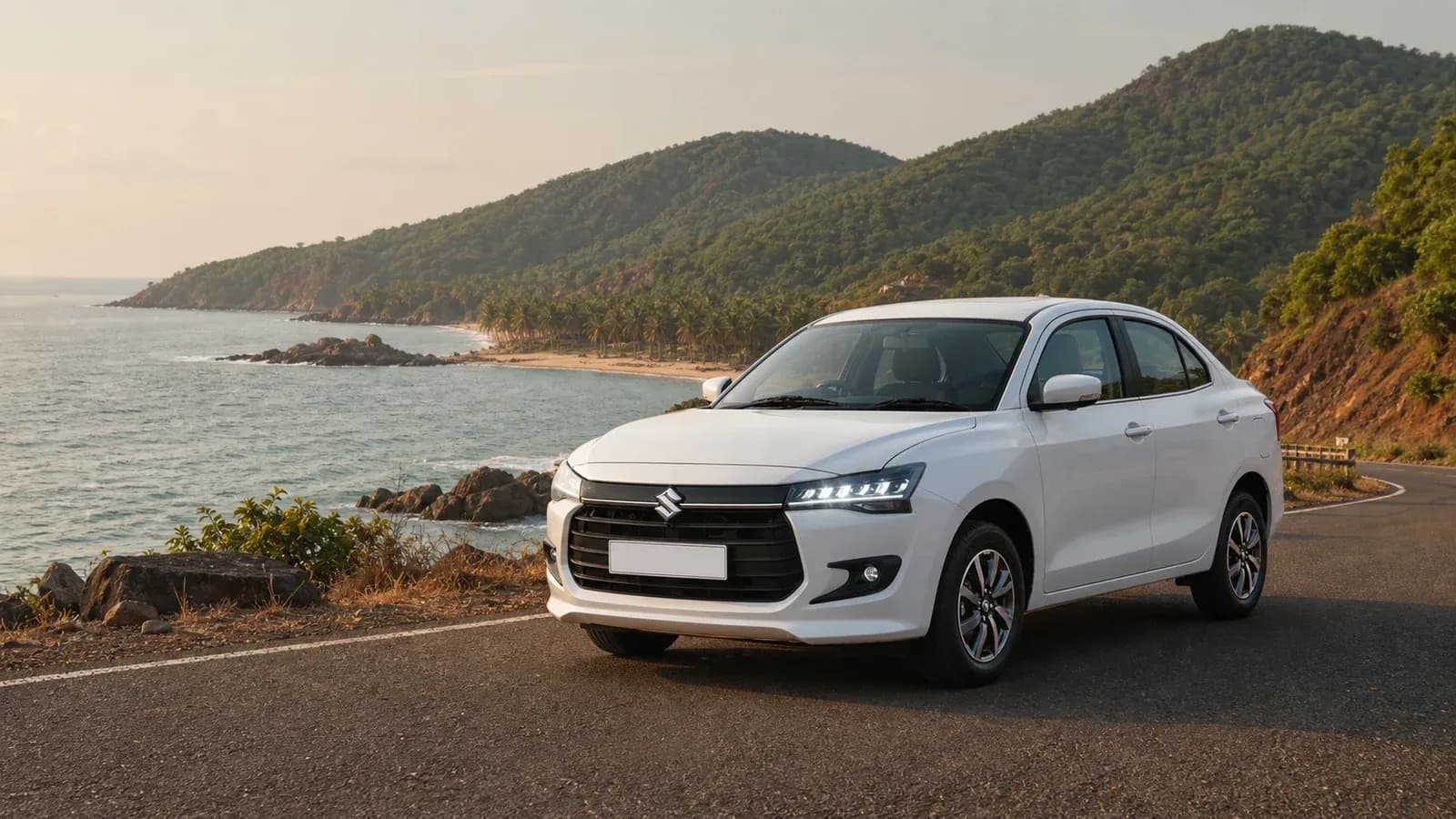 White Maruti Suzuki Dzire on a coastal road overlooking Gokarna