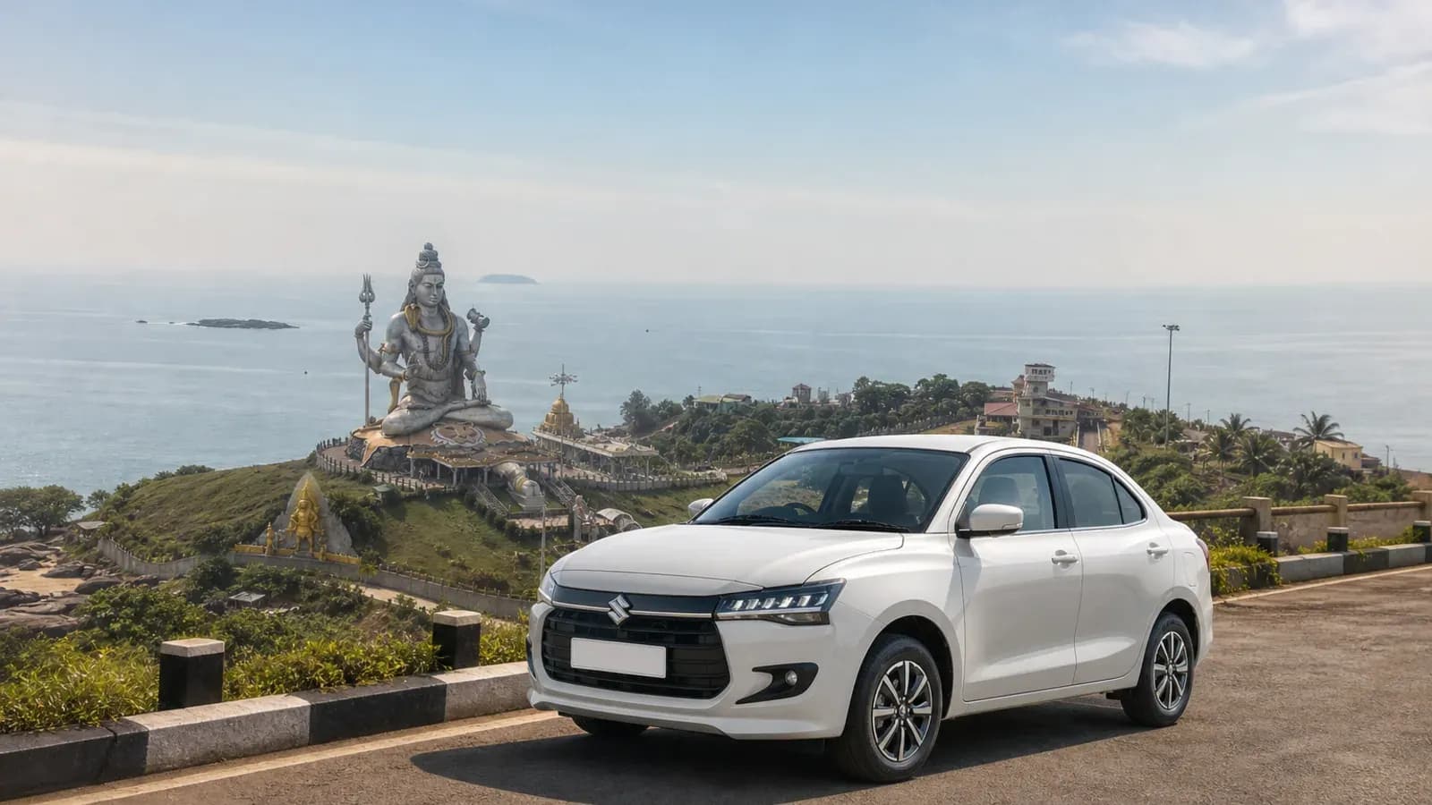 White Maruti Suzuki Dzire arriving above the Murudeshwar temple coastline