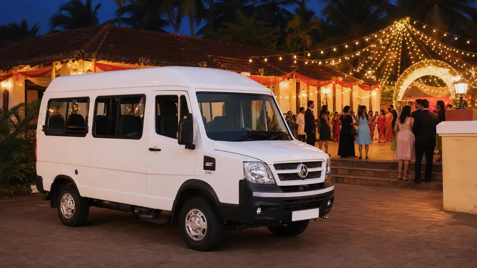 White Tempo Traveller waiting outside a Goan wedding venue
