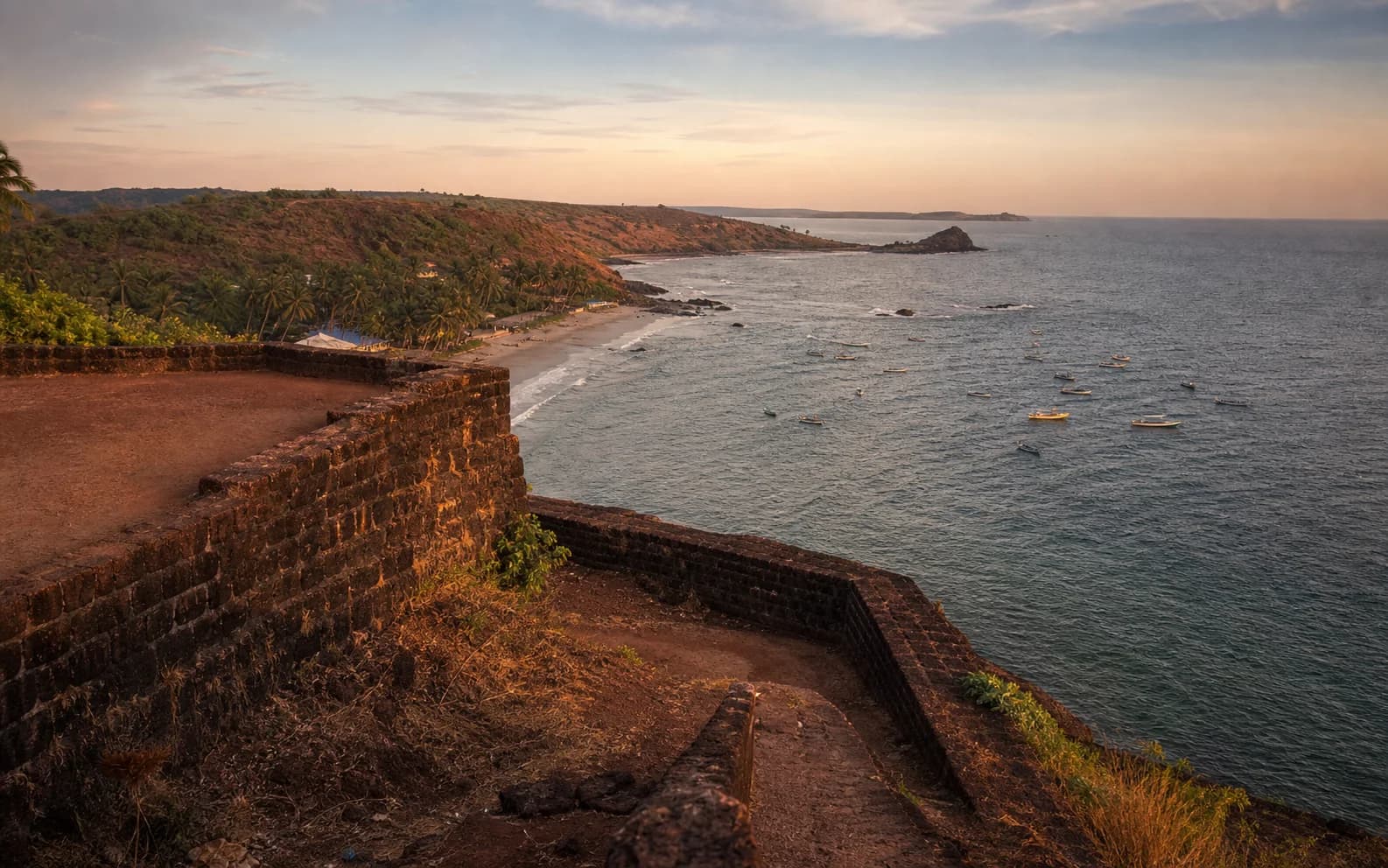 North Goa coastline seen from a warm laterite fort at sunset